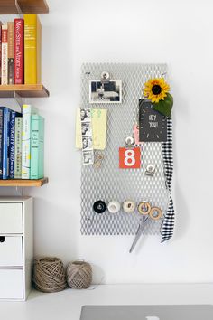 a white desk with a laptop and some books on it, along with other office supplies