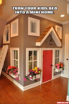 a kid's house with flowers in the window boxes and stairs leading up to it