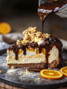 someone drizzling chocolate on top of a cheesecake covered in orange slices