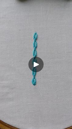 a video demonstrating how to make a crochet knot on a piece of fabric