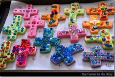 decorated cookies are arranged on a baking sheet