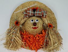 a straw hat with a scarecrow's face on it