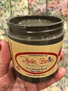 a hand holding a jar of dixie bee frosting