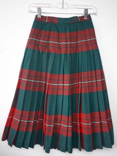 Beautiful 1950s Pendleton reversible a-line wool skirt. It's two skirts in one! One side is red plaid, and the other side is green and red plaid! There is minor wear, but nothing too noticeable. It has two red plastic buttons that are slightly different.   Brand: Pendleton Woolen Mills, The Reversible Skirt  Decade: 1950s Material: Wool Dry Clean Only Waist: 22 inches around Width at the bottom: 70 inches Full Length: 28  inches 1 inch buttons *Please read before buying* All sales are final. Be Vintage Plaid Skirt For School, Wool Ideas, Reversible Skirt, Pendleton Woolen Mills, Maroon Dress, Patchwork Skirt, Wool Skirt, 50s Fashion, Green And Red