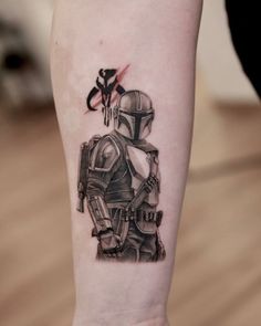 a tattoo on the arm of a person with a star wars boba fett