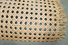 a piece of woven material with holes in the center and small circles at the top