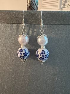 Beautiful blue & white ceramic bead and faux pearl earrings.  French hooks with a drop length of approx. 2" Handmade Blue Dangle Pearl Earrings, Handmade Blue Pearl Earrings, Blue Pearl Dangle Earrings, Elegant White Earrings With Large Beads, Adjustable White Pearl Earrings With Round Beads, Blue White Ceramic, Faux Pearl Earrings, Ceramic Beads, Diy Earrings