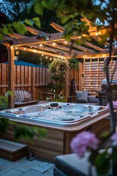 an outdoor hot tub in the middle of a backyard with string lights on it's roof