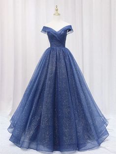 Dazzle the crowd in this Shiny Off Shoulder Navy Blue Prom Dress. The ball gown silhouette in rich navy blue exudes a timeless charm, while layers of glittering tulle add a breathtaking sparkle that’s perfect for a prom, graduation, or evening gala. The off-the-shoulder neckline gracefully highlights your shoulders, cr Junior Prom Dress, Graduation Dresses Long, Navy Blue Prom Dresses, Long Party Dress, Dresses 2022, Junior Prom Dresses