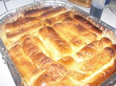 a pan filled with bread sitting on top of a counter