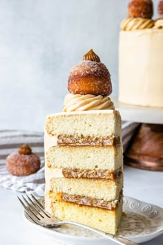 a piece of cake on a plate with a fork in front of it and the rest of the cake behind it