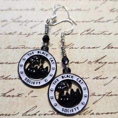 Enamel Black Cat Society Dangle Earrings with Black Faceted Glass Bead. Dangle approx 2".  Hypo-allergenic sterling silver ear wires. Black Cat Design Drop Earrings, Black Hypoallergenic Sterling Silver Jewelry, Black Hypoallergenic Metal Earrings, Black Hypoallergenic Adjustable Earrings, Hypoallergenic Black Metal Jewelry, Witchy Tips, Faceted Glass, Lebanon, Glass Bead