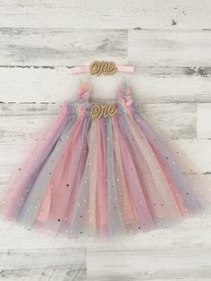 This listing is for a rainbow tulle tutu dress, and your option of matching headband! Perfect for that 1st birthday!!  ~headband elastic can be made in any color! ~ ships within 1 to 3 business days (message me with any additional questions)! ~ headband backed with felt for comfort {{SIZING}}  6-9 months (fits 18-20 lbs.) 9-12 months (fits 20-22 lbs.) 12-18  months  (fits 22-26 lbs.) 18-24 months  (fits 26-30 lbs.)  Don't forget to like my Facebook page for 10% off coupon https://www.facebook.co Whimsical Rainbow Tulle Tutu Dress, Summer Princess Tutu Dress In Glitter Tulle, Summer Princess Style Tutu Dress In Glitter Tulle, Whimsical Tulle Tutu Dress For First Birthday, Whimsical Tulle Tutu Dress For Birthdays, Whimsical Tulle Tutu Dress For Birthday, Princess Tulle Tutu Dress For First Birthday, Princess Style Tulle Tutu Dress For First Birthday, Multicolor Tulle Fairy Dress For Birthday