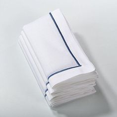 a stack of folded white towels sitting on top of a table