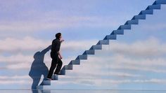 a man standing on top of a stair leading up to the sky with his shadow