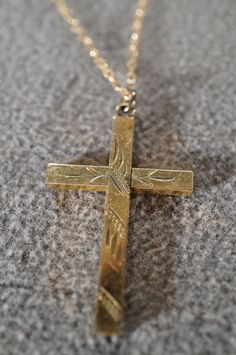 I am offering this fabulous vintage 12K gold filled necklace. This piece is truly gorgeous, and it has the following features: * beautiful vintage necklace * religious * cross * etched * dangle * 18 inches in length This is a fantastic and classic piece. There is tons of sparkle and shine with this piece. It will beautifully complement your upcoming fashion season. Buyer pays all shipping and handling. Elegant Brass Cross Pendant Necklace, Vintage Yellow Gold Cross Pendant Necklace, Antique Yellow Gold Cross Pendant Jewelry, Vintage Brass Cross Necklace, Antique Hallmarked Cross Pendant Jewelry, Vintage Beads Necklace, Red Pendants, Gold Filled Necklace, Religious Cross