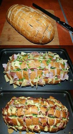 two trays with sandwiches on them and a loaf of bread in the back ground