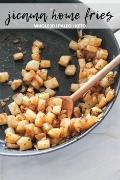 the food is being cooked in the skillet on the stove with a wooden spoon