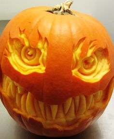 a carved pumpkin with an evil face on it