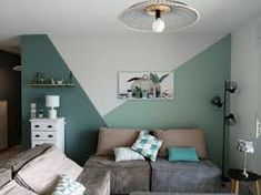 a living room filled with furniture and green walls