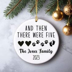 a personalized ornament for the family that has their dog's paw prints on it