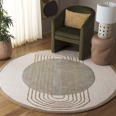 a green chair sitting on top of a wooden floor next to a white round rug