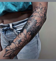 a woman's arm with flowers on it