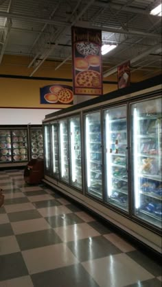 an empty grocery store with refrigerators full of food