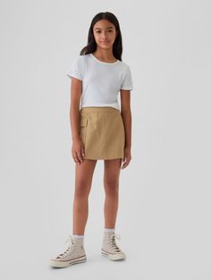 Smooth woven cotton-Tencel blend skort.  E-waist at back, concealed hook and bar closure at front.  Cargo pocket.  Inner shorts, wrap-style front.  This product was made in a factory that invests in gender equality and women’s empowerment.  Through RISE Reimagining Industry to Support Equality) and Gap Inc. ’s program P. A. C. E.  Personal Advancement & Career Enhancement), we support people who make our clothes to build the skills, knowledge, confidence, and resilience needed to advance in work Wrap Skort, Gender Equality, Support People, Cargo Pocket, Gap Kids, Short Girls, Above The Knee, New Woman, Cotton Weaving