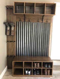 a wooden bench with several pairs of shoes sitting on it's shelf next to a metal wall