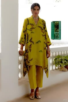 Mustard asymmetric kurta with Malabar, squirrel hand painted kalamkari patterns. Comes with pant. Components: 2 Pattern: Hand Painted Type Of Work: Malabar, Squirrels, Kalamkari Neckline: V Neck Sleeve Type: Three Quarter Fabric: Hand Spun Cotton Color: Yellow Other Details:  Kurta length: 44 inches Disclaimer: Pure hand painted kalamkari pieces will have irregularities, no pieces will be identical Occasion: Work - Aza Fashions Archana Jaju, Hauz Khas, Pakistani Formal Dresses, Ikat Dress, India Dress, Iranian Women Fashion, Kurta Neck Design