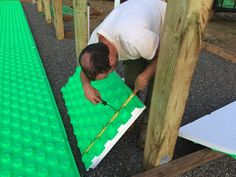 a man in white shirt working on green mat