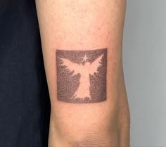 a person with a tattoo on their arm that has an image of a dove in it