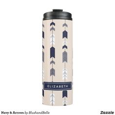 a white and blue travel mug with an arrow pattern on the side that says elizabeth