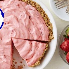 there is a pie on the table with strawberries next to it