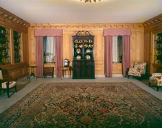 the room is decorated with antique furniture and rugs