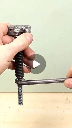 two hands are holding a screw and fixing it