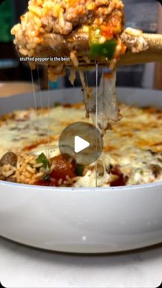 a person scooping some food out of a bowl