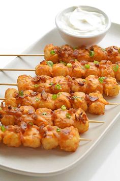 chicken skewers with ranch dressing on a white platter