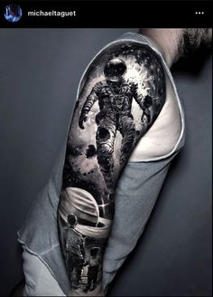 a man with an astronaut tattoo on his arm