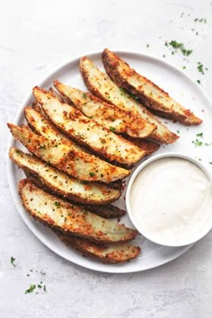 grilled eggplant fries on a white plate with ranch dip in the middle