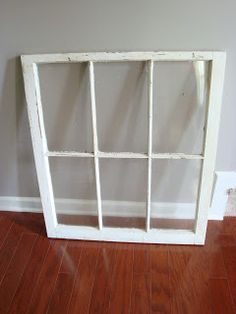 an old window sitting on top of a hard wood floor