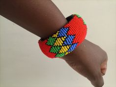 African Maasai bracelets, Zulu bracelets, Beaded bangles, Wrist bracelet, Leather bracelet, Tribal bracelet, Boho bracelets, Women bracelets These superbly crafted Zulu beaded bracelets are made of fine beads which can be worn in any occasion. The bracelets are well beaded and can match any outfit. Primary Color: Red. Secondary Color: yellow, green & blue Can be customized in different colors. **Bracelet size is 7.5 inches for a normal wrist. If you have a larger wrist kindly let me know**    Th Unique Hand-strung Bangle Bracelet, Handmade Adjustable Bangle With Round Beads, Festival Bangle Beaded Bracelets, Multicolor Beaded Bangle For Festival, Multicolor Bangle With Colorful Beads For Festival, Traditional Handmade Stretch Bangle Bracelet, Handmade Traditional Stretch Bracelet, Traditional Handmade Bangle Stretch Bracelet, Adjustable Multicolor Jubilee Cuff Bracelet