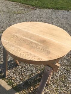 a wooden table sitting on top of gravel