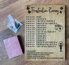 a wooden card game with instructions for how to play the game on it and some rubber stamps