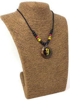 "Rasta Necklace. Handmade Rastafarian Design. Unisex. Handmade with black cord, wooden beads and coconut shell wood pendant with rasta man design. Stylish Minimalist Design. Rastafarian Necklace. Unisex Design. Necklaces is 16\" inches Around the neck. And the wooden pendant is 1\" Inch long. Comfort Fit Necklace. FAST & FREE SHIPPING! First Class Mail Visit my Etsy Shop to see more Designs! Handmade Rasta Wooden Earrings, Rasta Bracelets and Necklaces. Click here to see more designs: https: Black Artisan Necklaces For Beach, Black Artisan Necklace For Beach, Artisan Black Necklace For Beach, Traditional Black Necklaces For Beach, Traditional Black Necklaces For The Beach, Black Wooden Beads Necklace For Beach, Black Wooden Beaded Necklace For Festivals, Rasta Necklace, Rasta Man