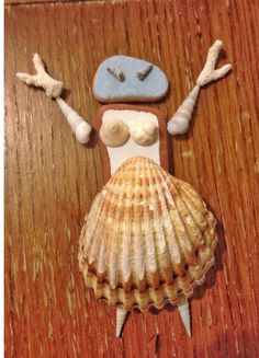 there is a shell and some seashells on the table with it's eyes closed