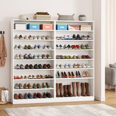 a white shoe rack filled with lots of shoes next to a rug on the floor