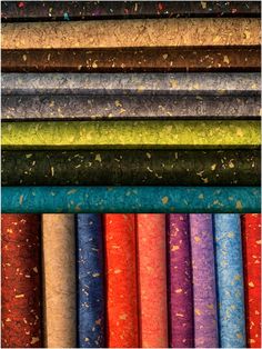 an assortment of different colored papers with sprinkles on them