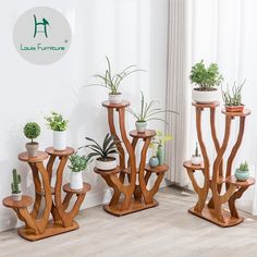 four wooden plant stands with plants in them